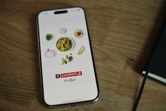 A cell phone sitting on top of a wooden table
