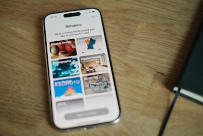 A cell phone sitting on top of a wooden table