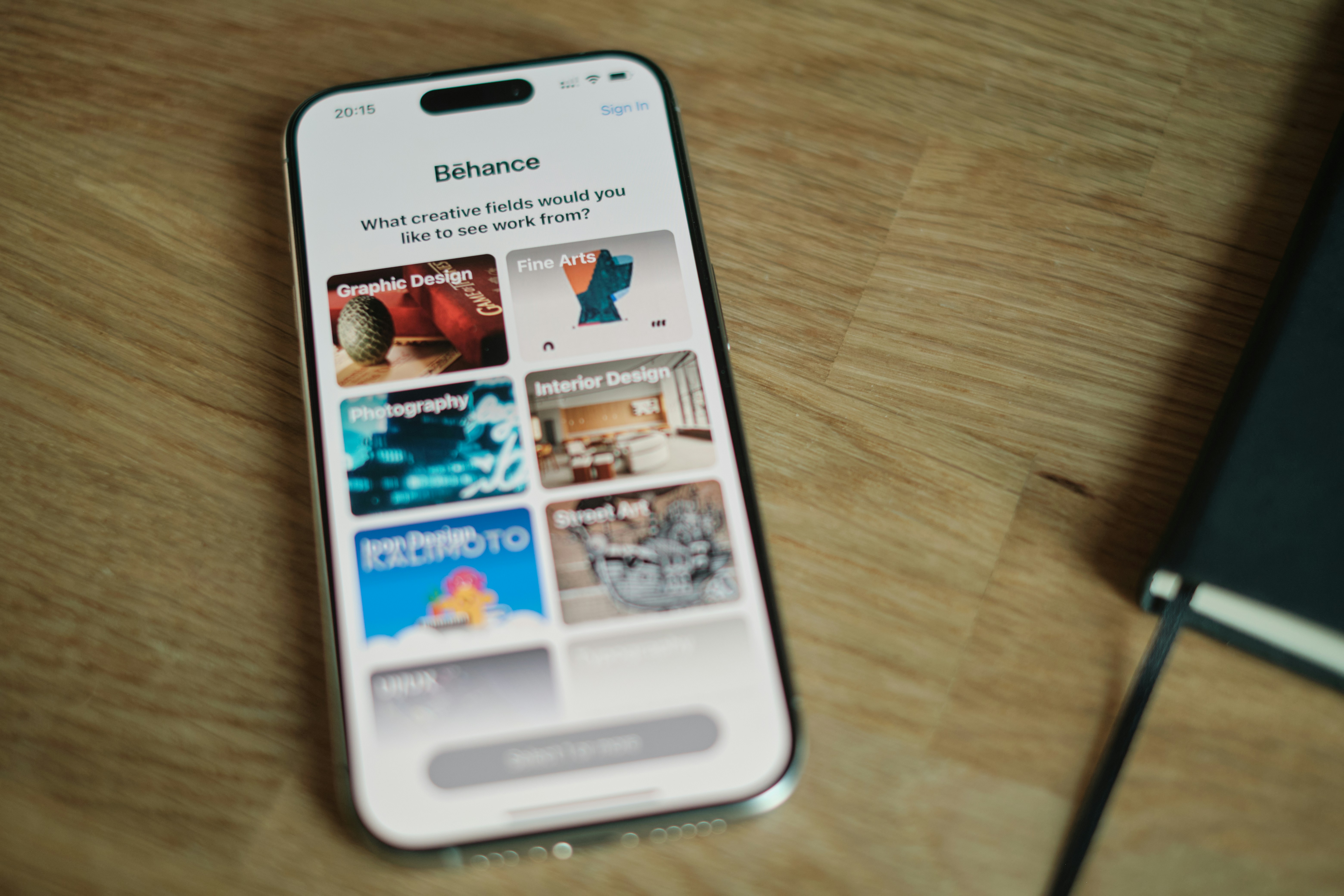 A cell phone sitting on top of a wooden table