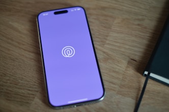 A cell phone sitting on top of a wooden table
