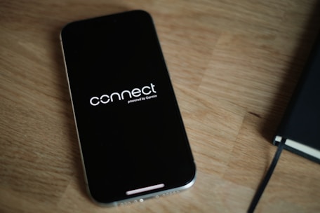 A cell phone sitting on top of a wooden table