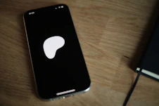 A cell phone sitting on top of a wooden table