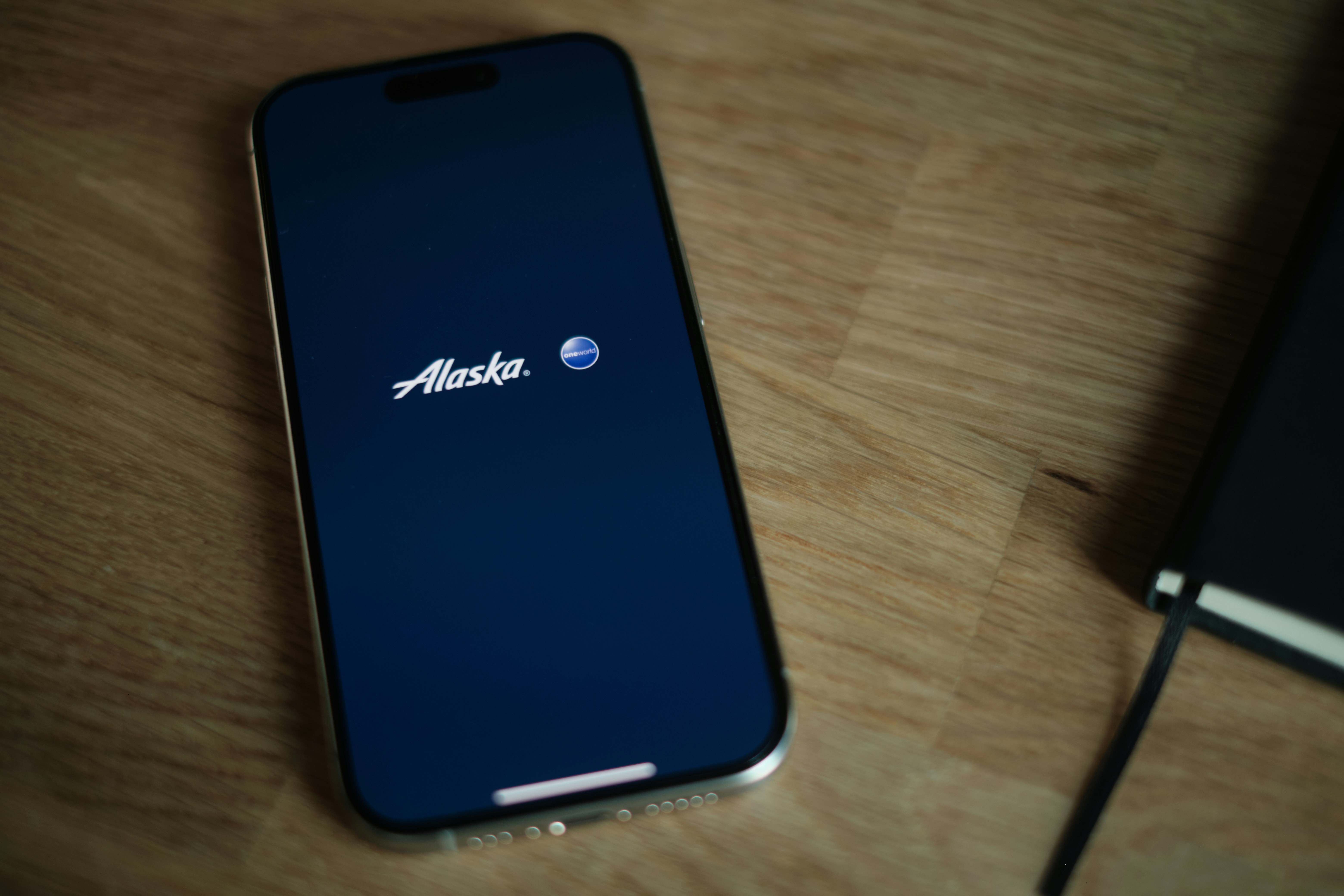 A cell phone sitting on top of a wooden table