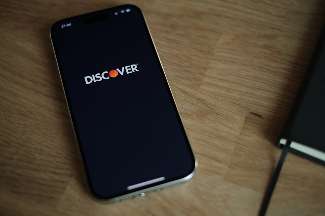 A cell phone sitting on top of a wooden table