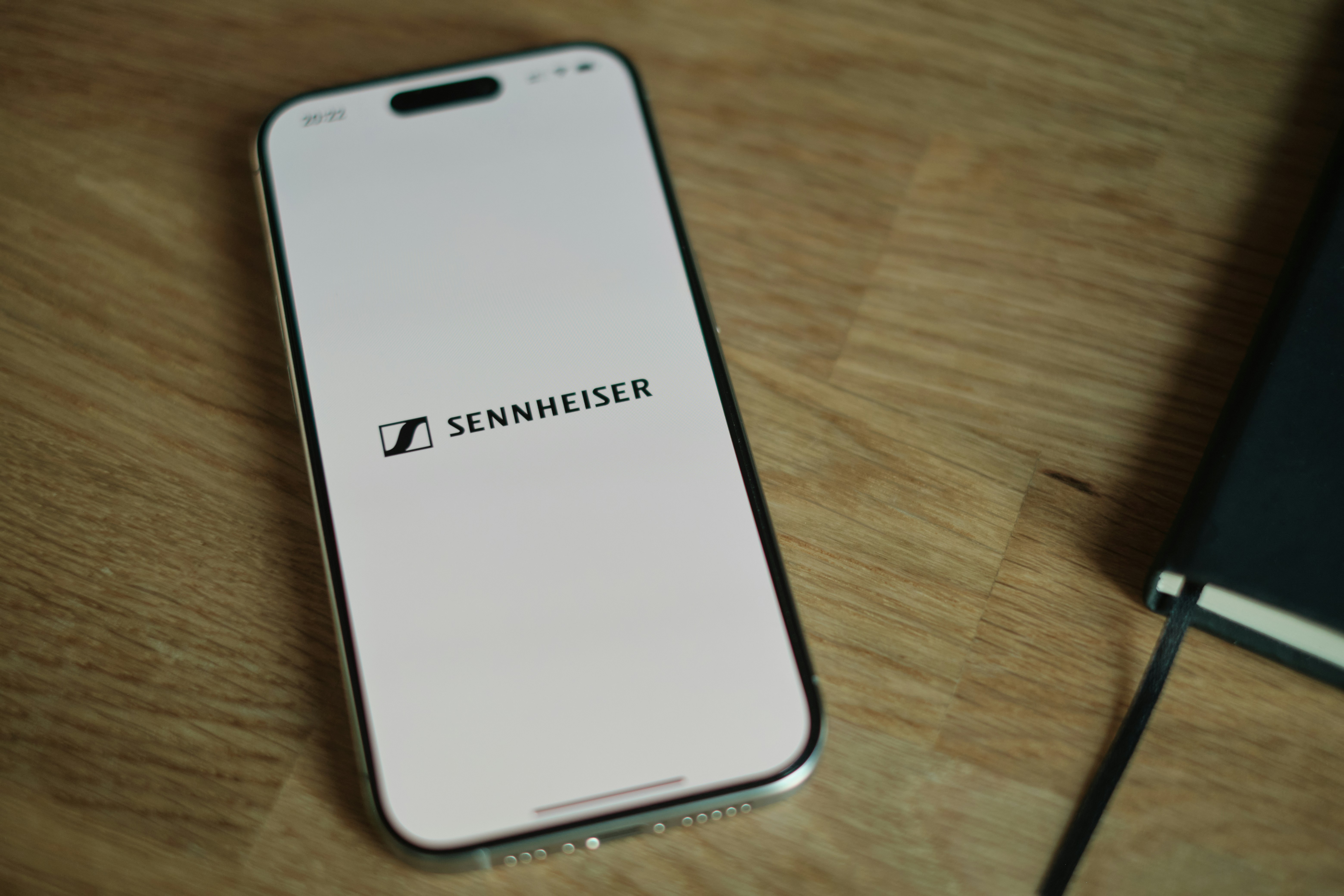 A cell phone sitting on top of a wooden table