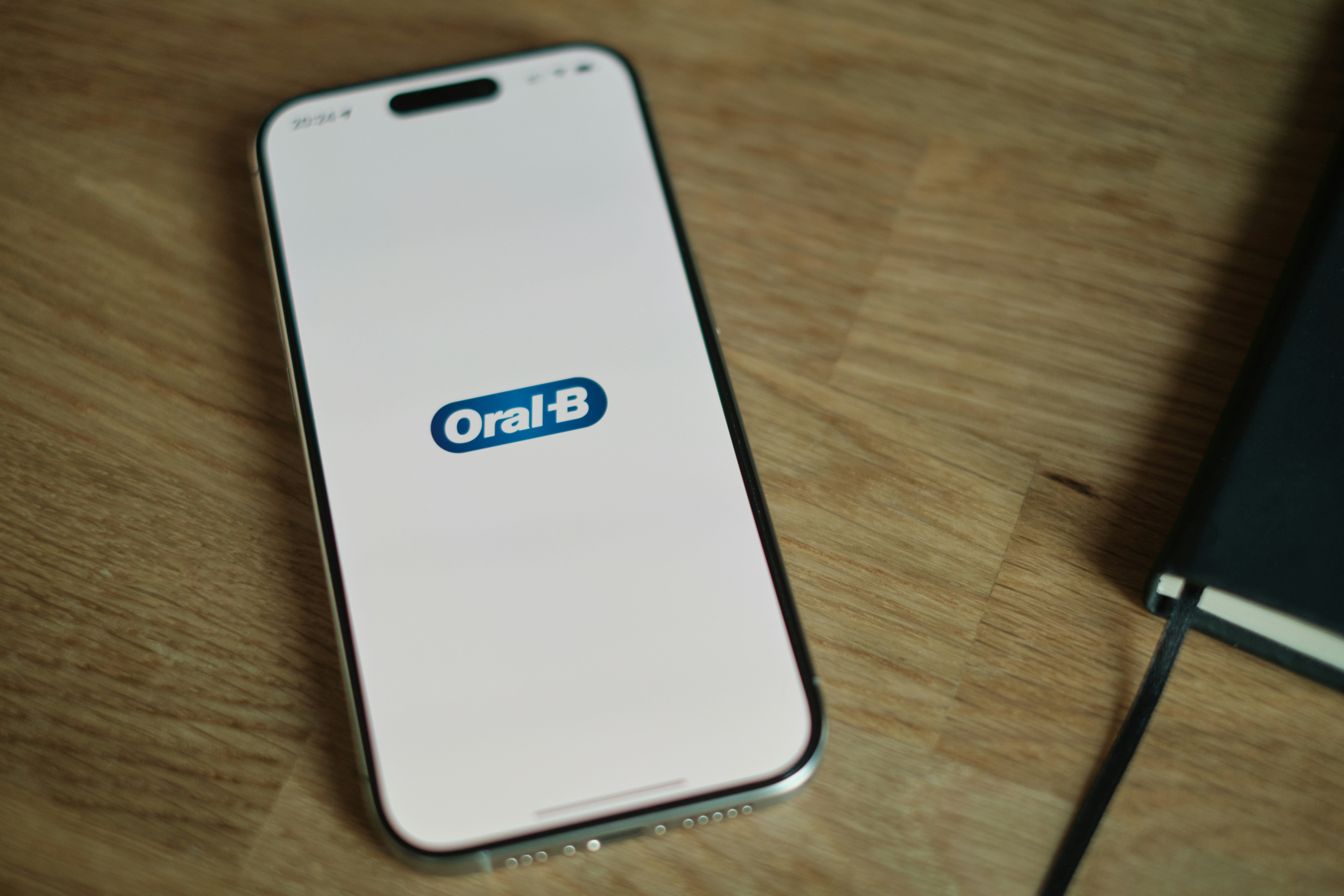 Un teléfono celular encima de una mesa de madera