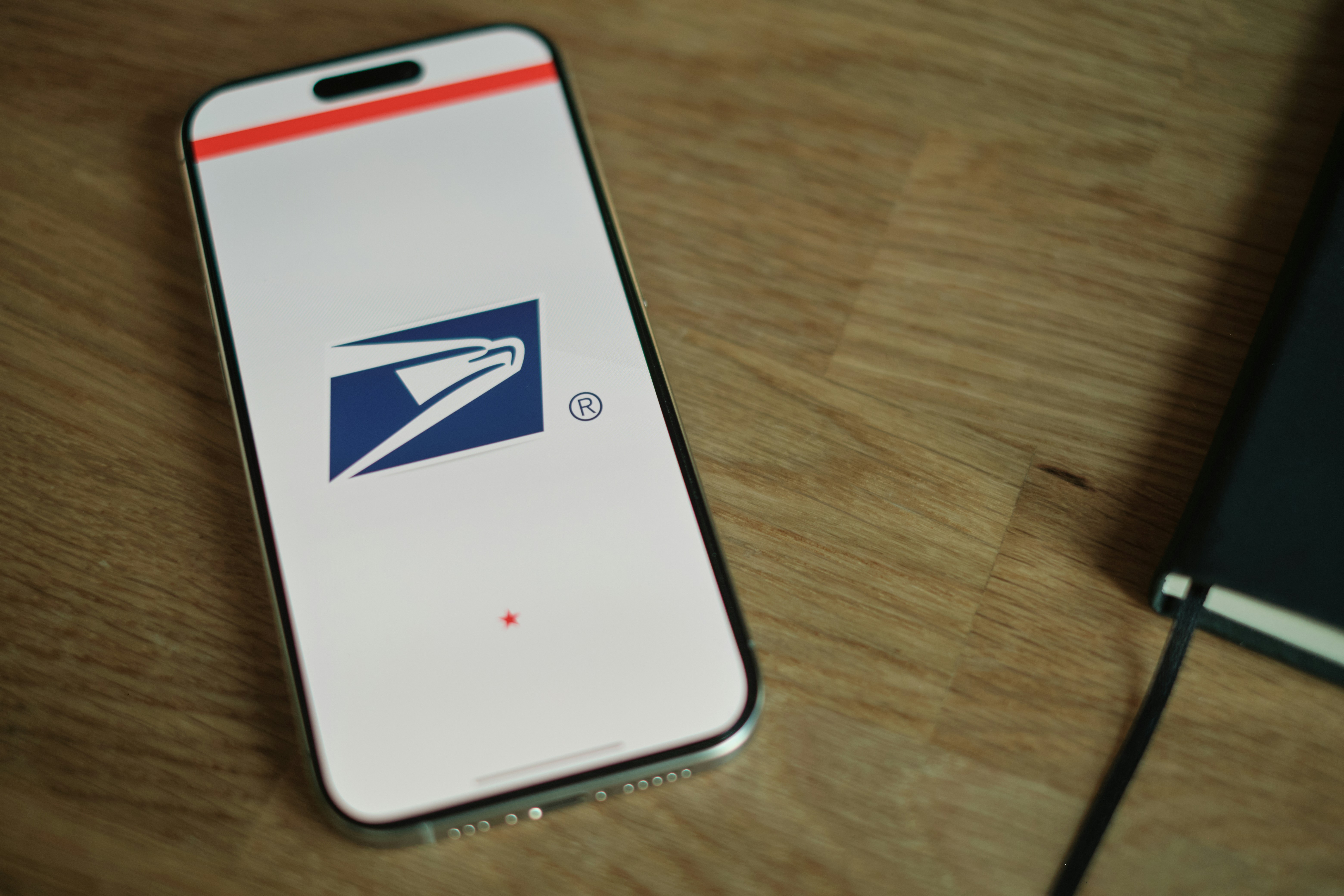 A cell phone sitting on top of a wooden table