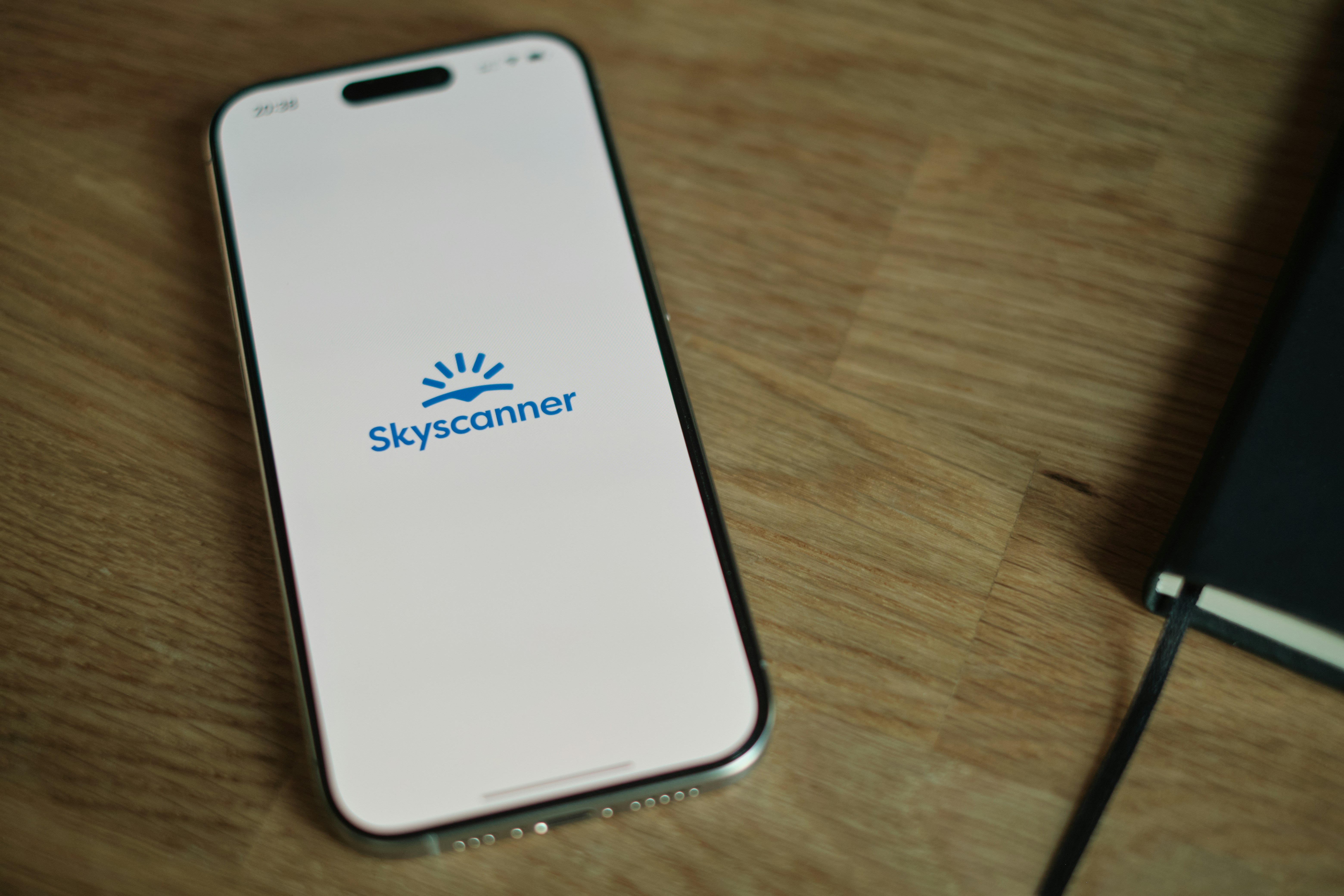 A cell phone sitting on top of a wooden table