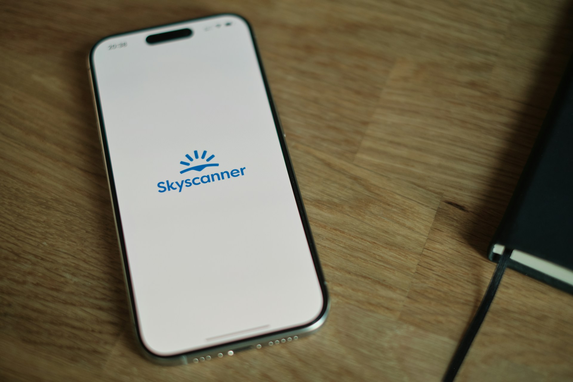 A cell phone sitting on top of a wooden table