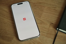 A cell phone sitting on top of a wooden table