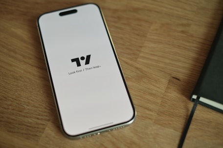 A cell phone sitting on top of a wooden table
