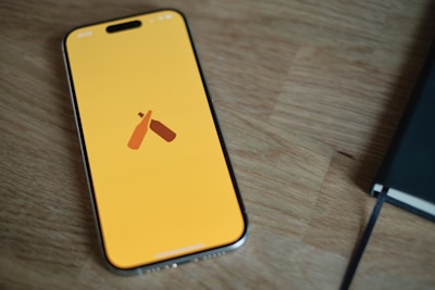 A cell phone sitting on top of a wooden table