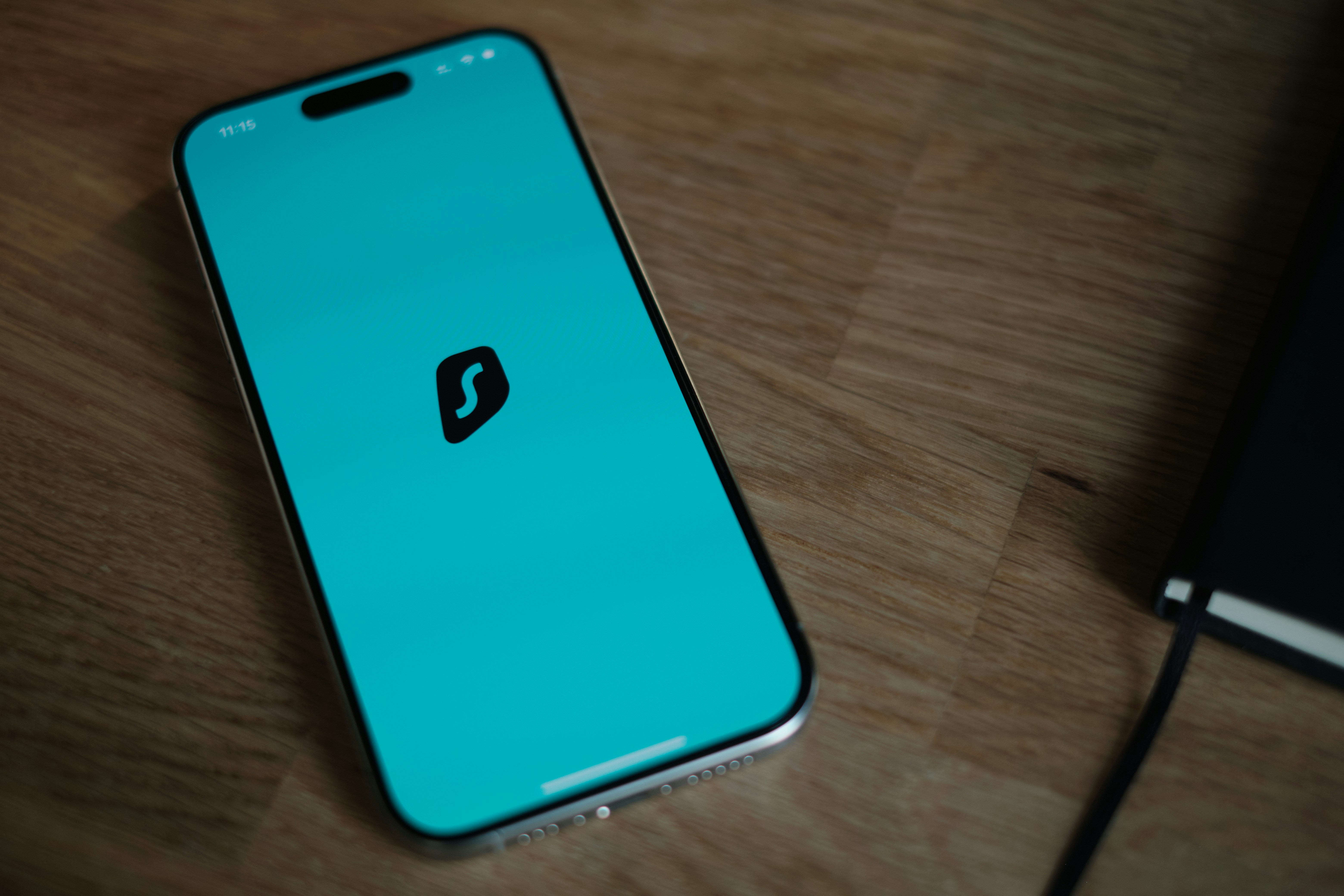 A cell phone sitting on top of a wooden table