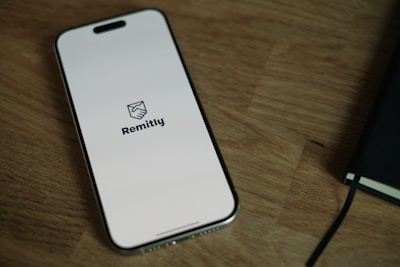 A cell phone sitting on top of a wooden table