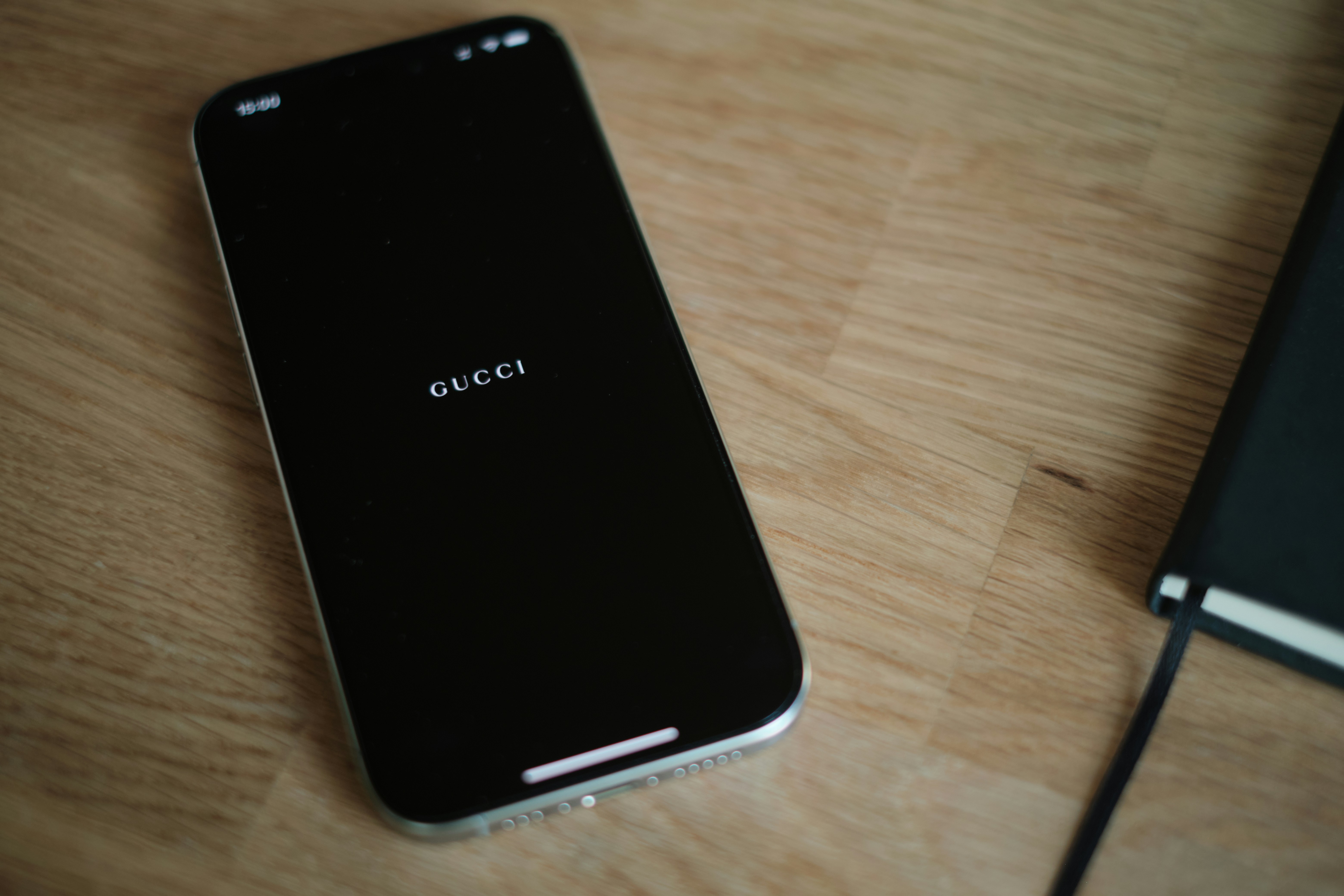 A cell phone sitting on top of a wooden table
