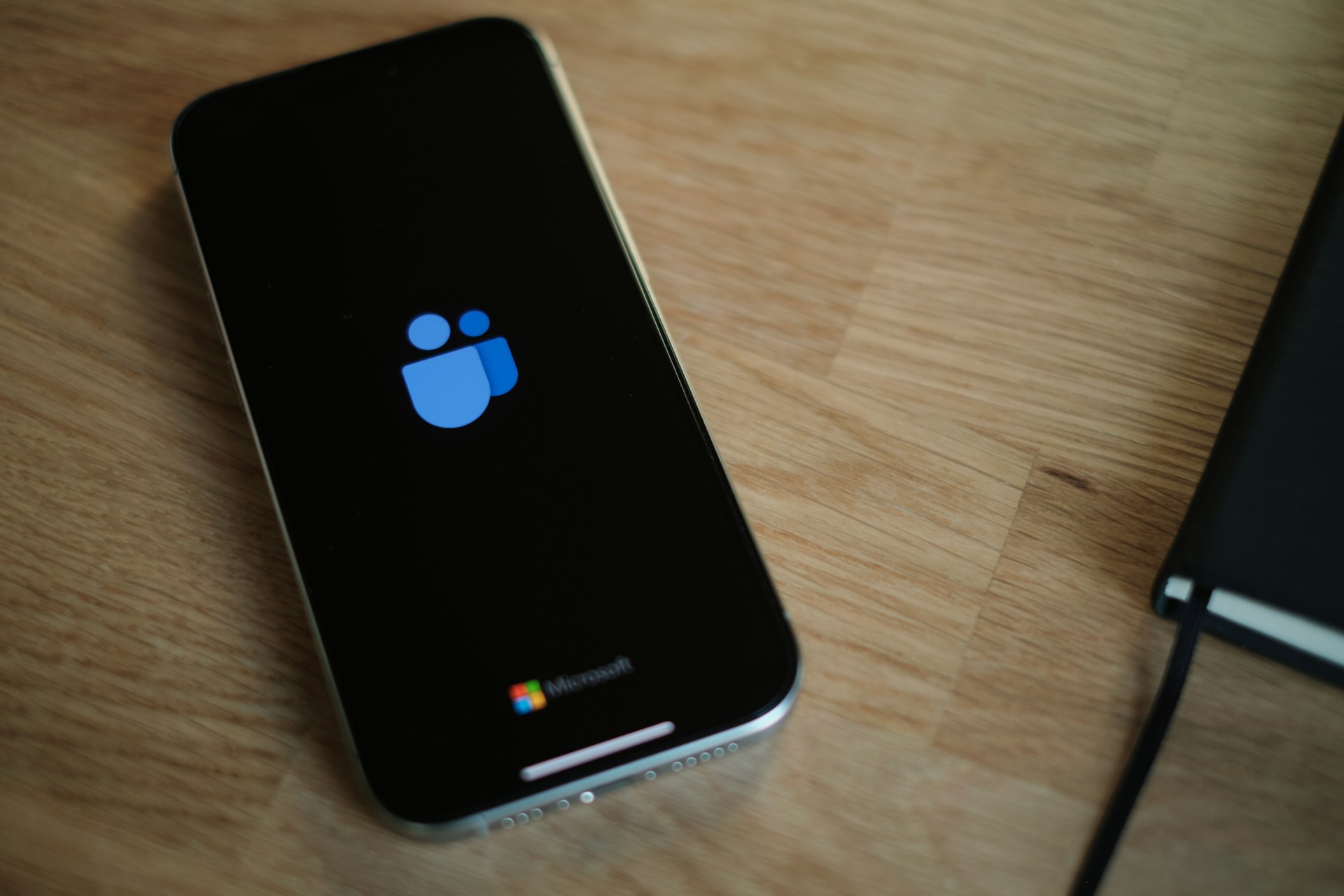 A cell phone sitting on top of a wooden table