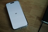 A cell phone sitting on top of a wooden table