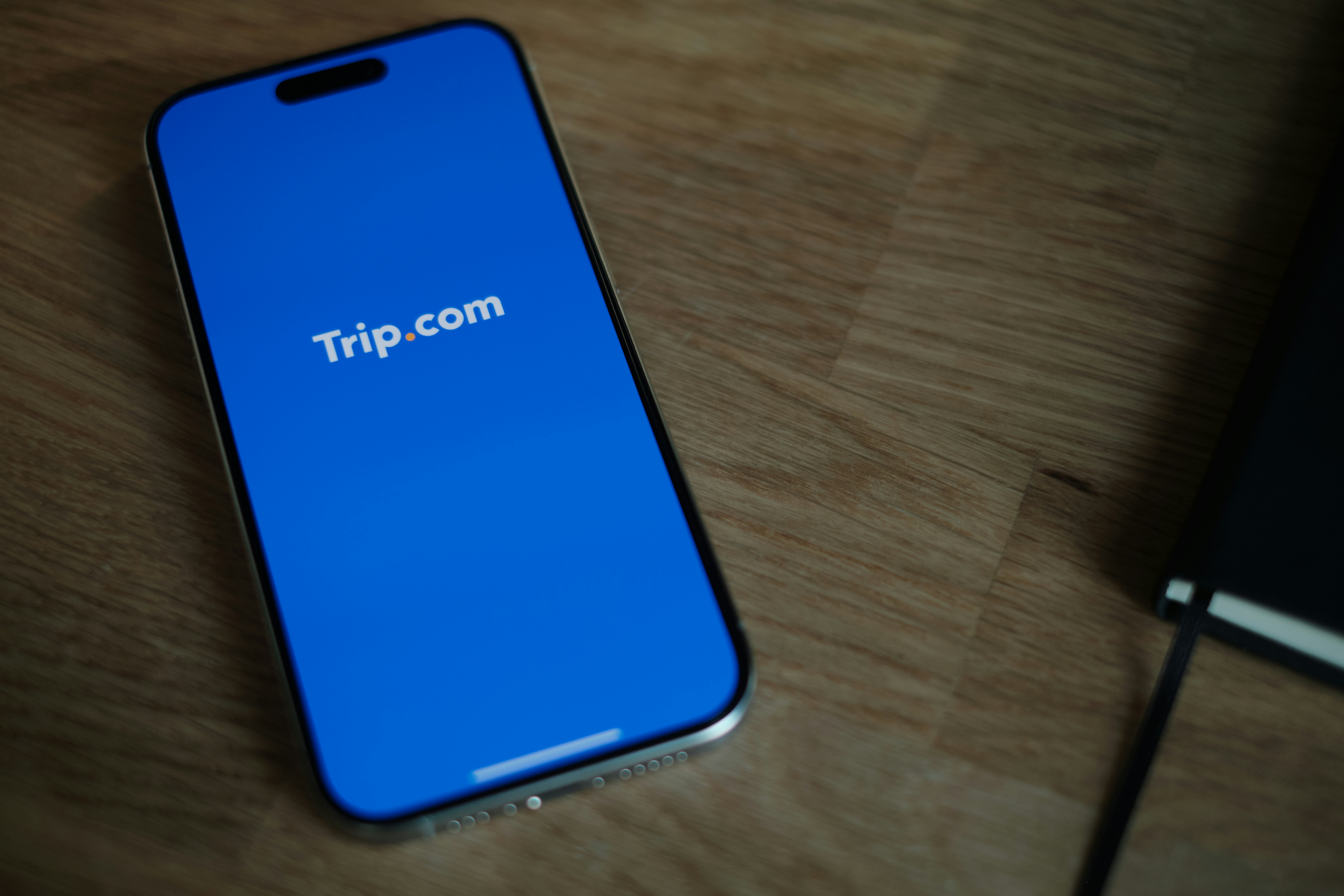 A blue iPhone sitting on top of a wooden table