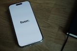 A cell phone sitting on top of a wooden table