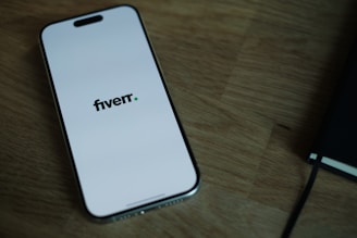 A cell phone sitting on top of a wooden table