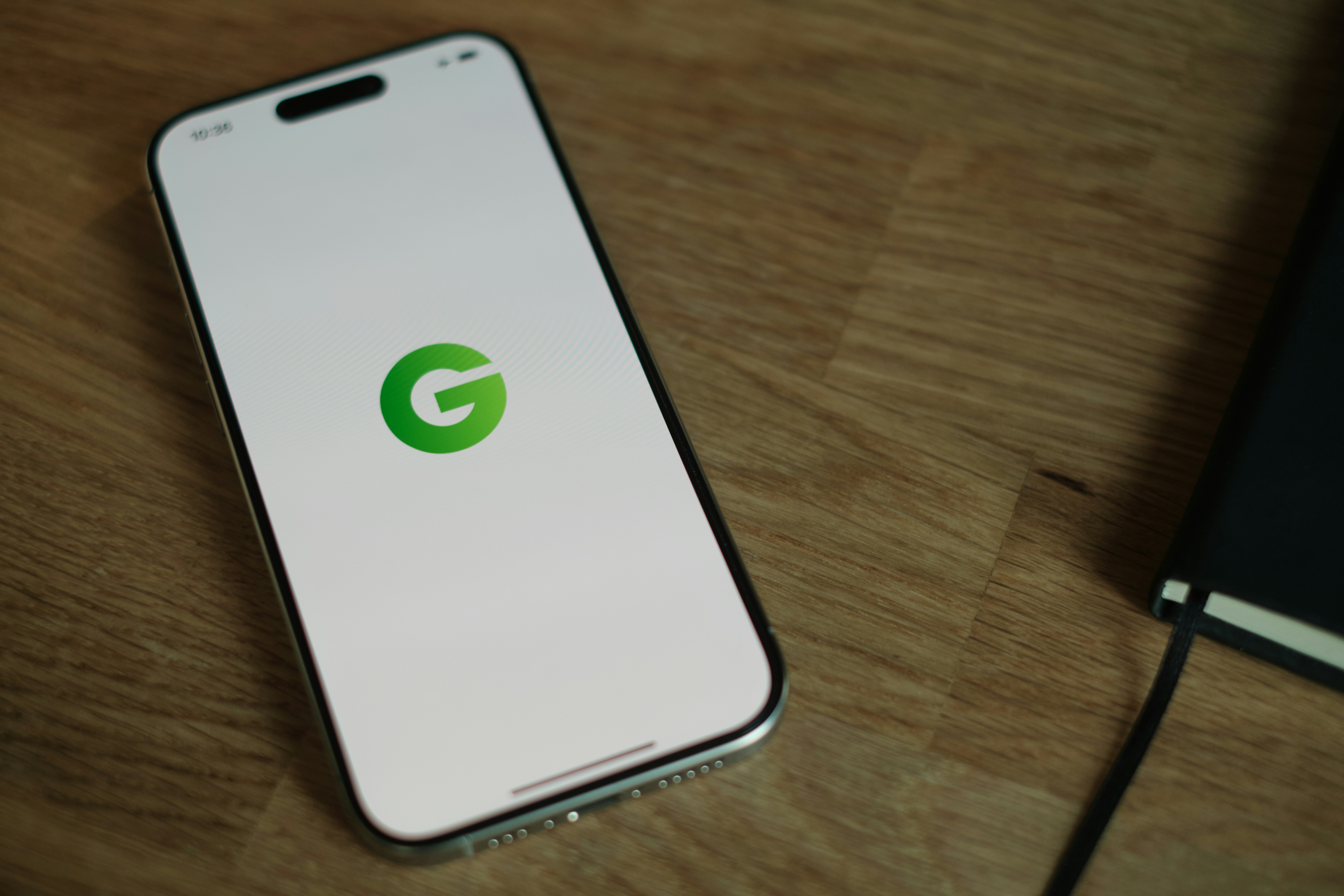 A cell phone sitting on top of a wooden table