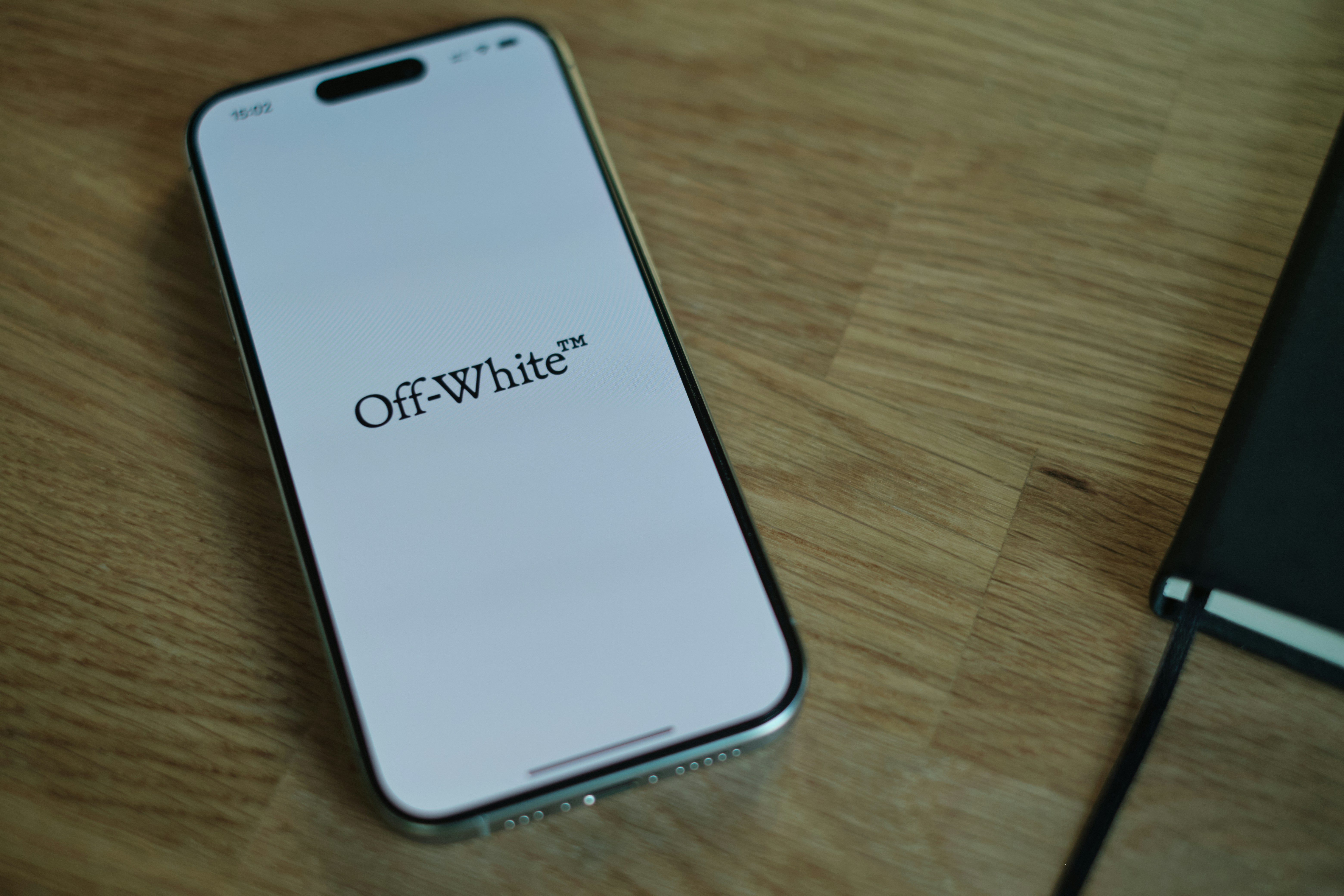 A cell phone sitting on top of a wooden table