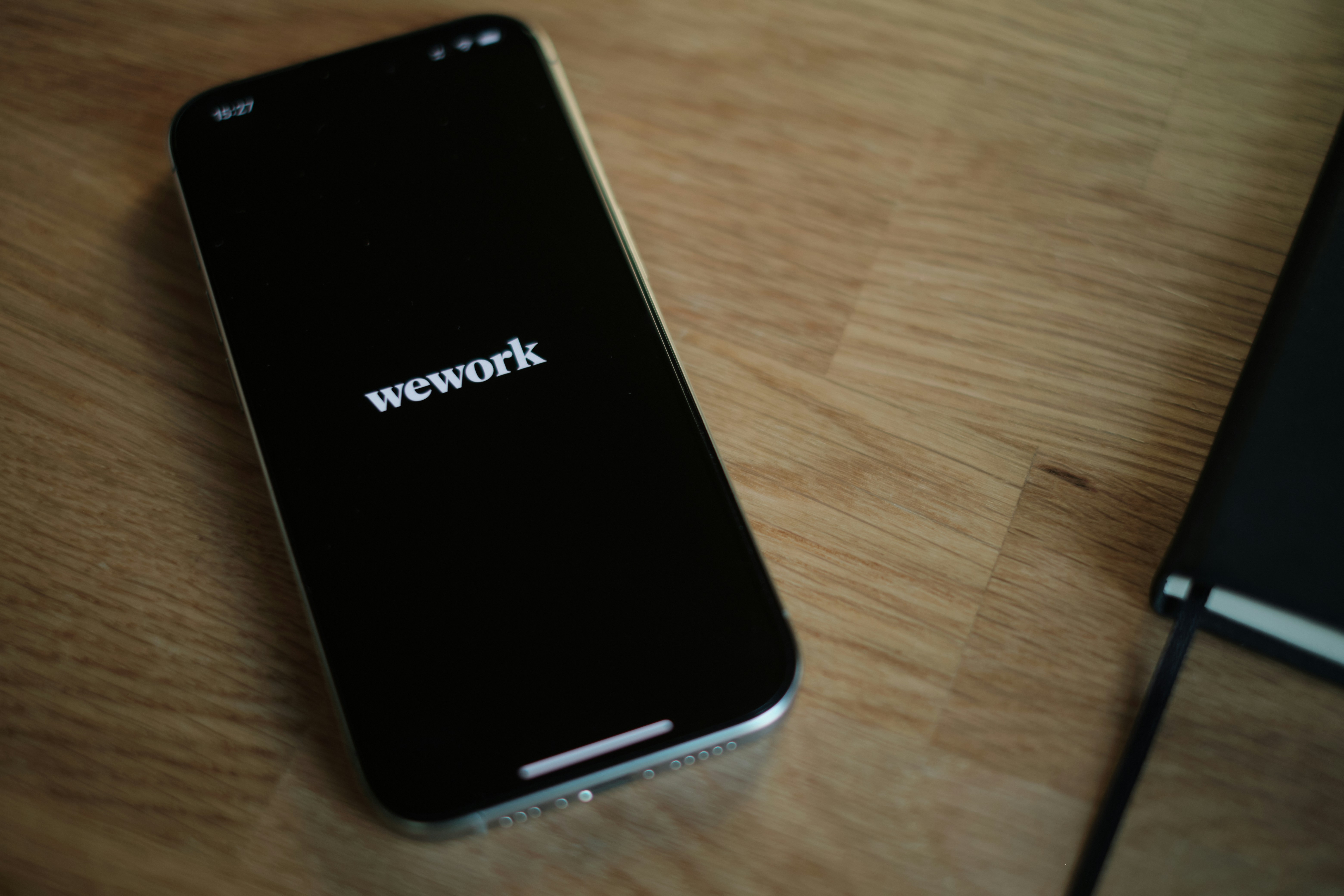 A cell phone sitting on top of a wooden table