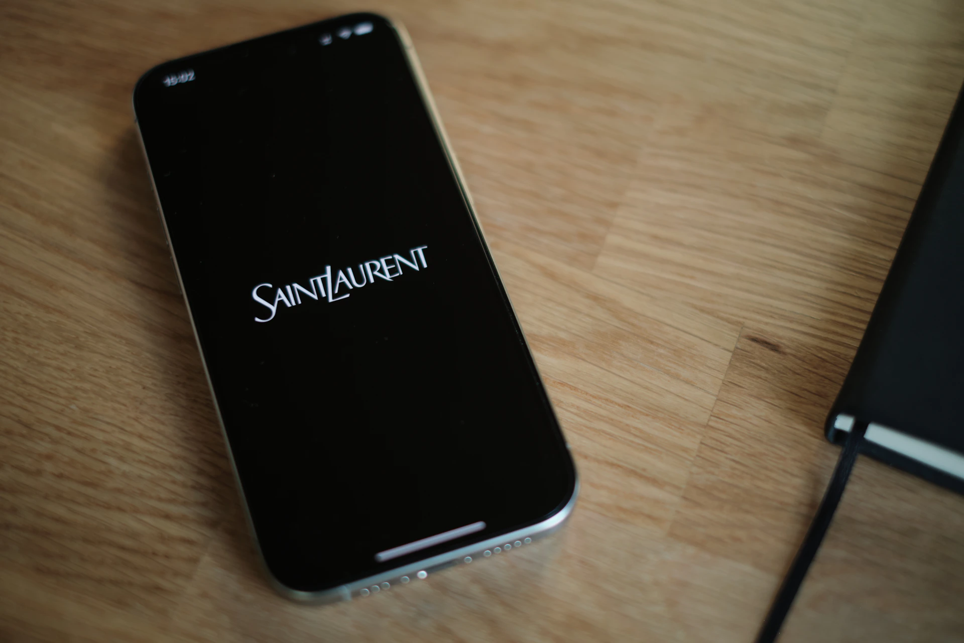 A cell phone sitting on top of a wooden table