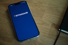 A phone sitting on top of a wooden table