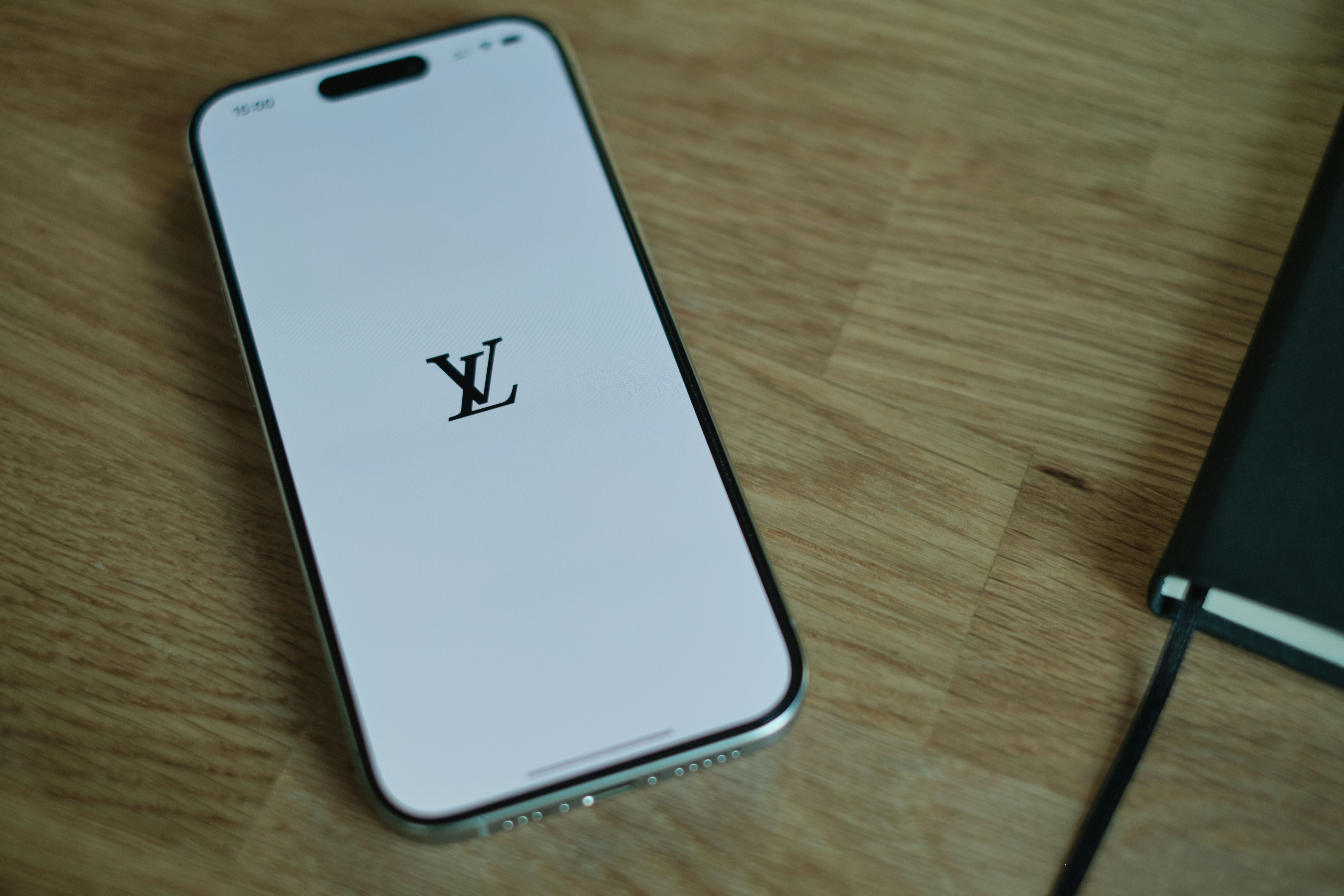 A cell phone sitting on top of a wooden table