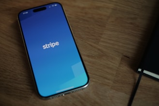 A cell phone sitting on top of a wooden table
