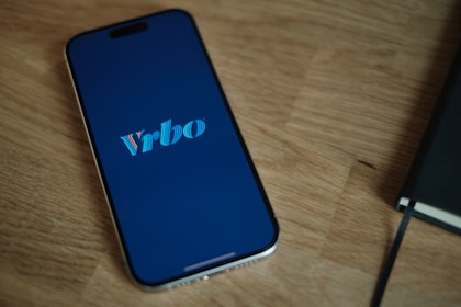 A cell phone sitting on top of a wooden table