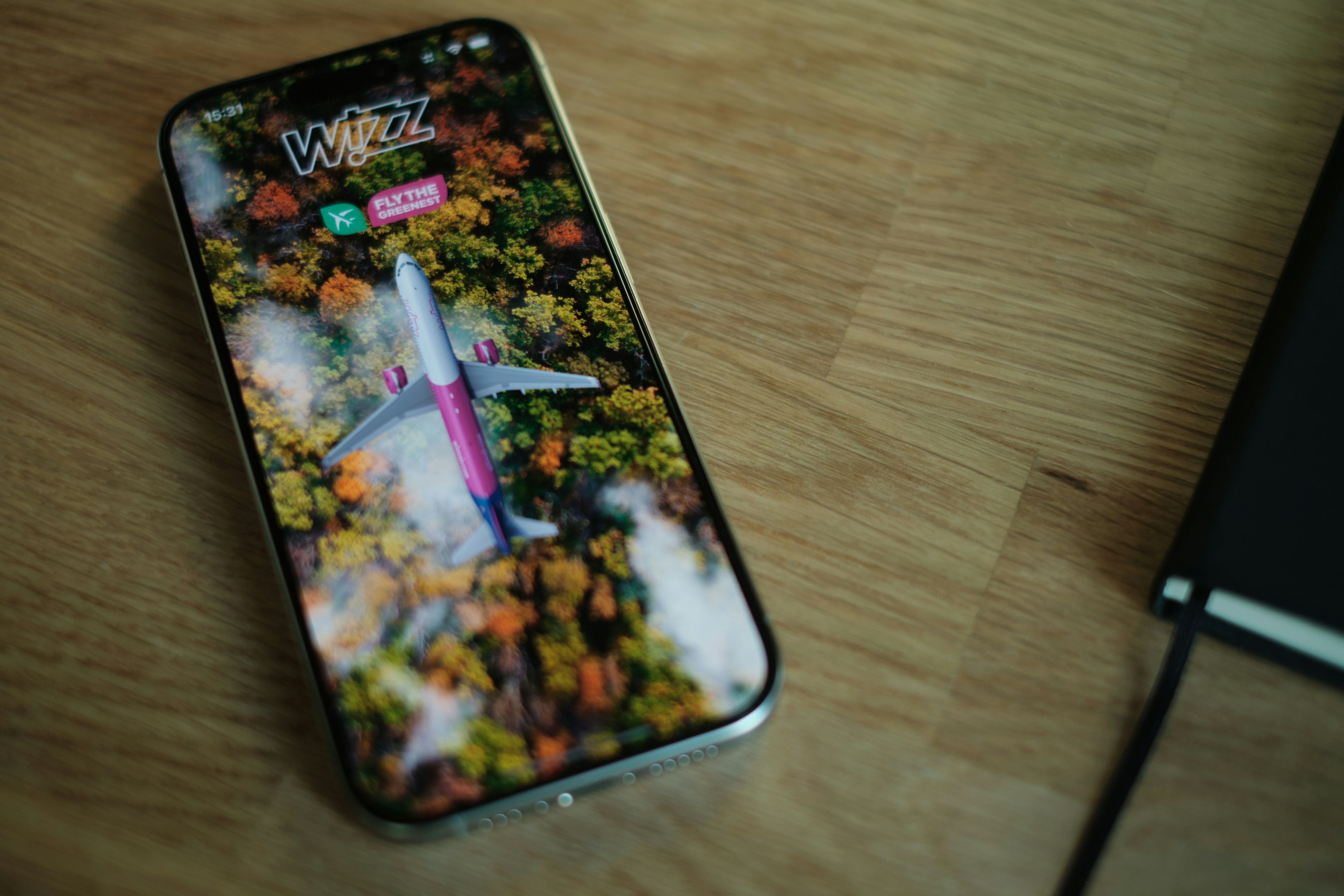 A cell phone sitting on top of a wooden table