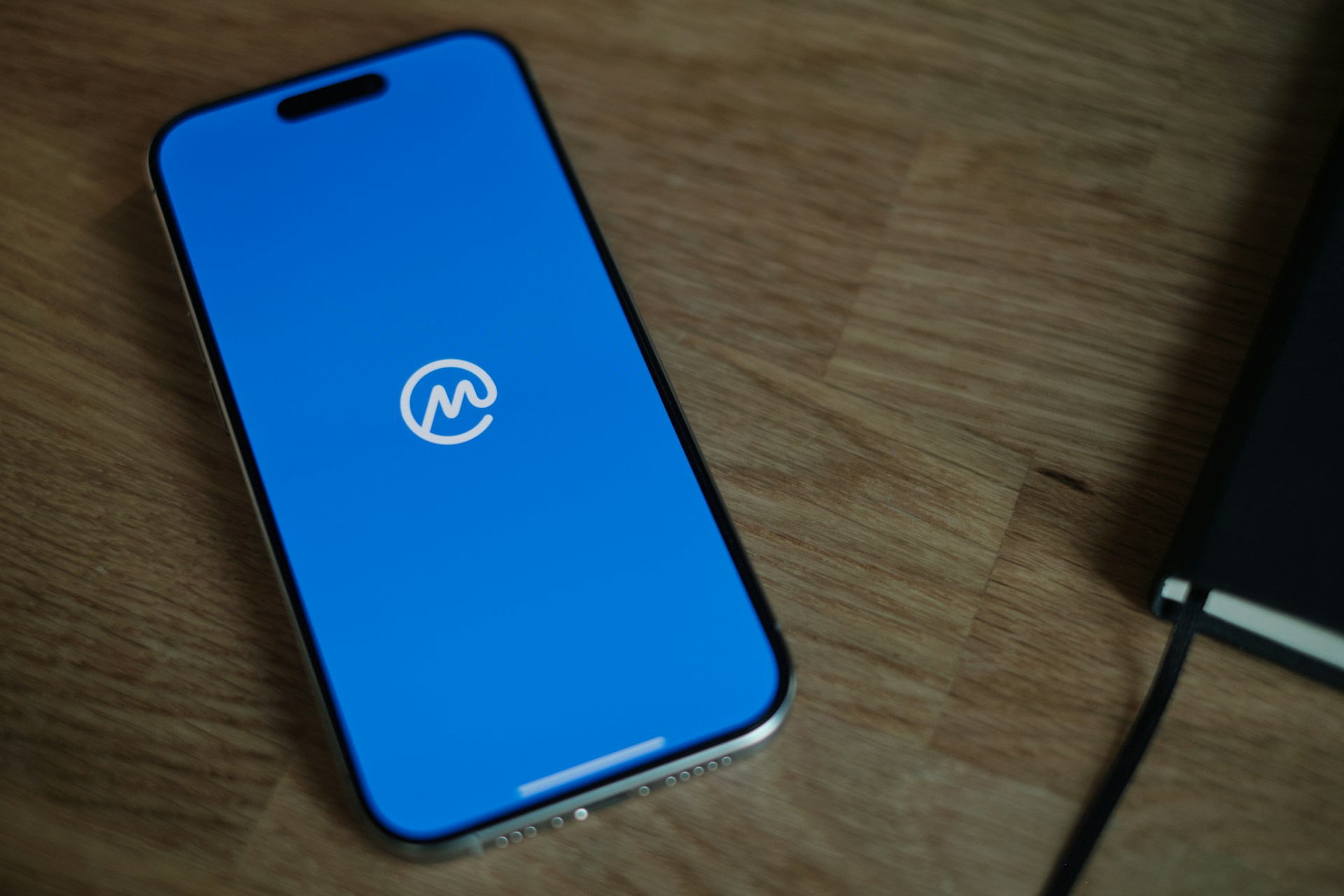 A cell phone sitting on top of a wooden table
