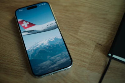 A cell phone sitting on top of a wooden table