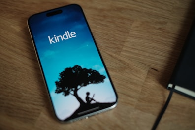 A cell phone sitting on top of a wooden table
