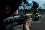 A man with a paintball gun in his hand