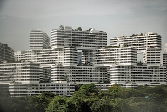 A very tall white building with lots of windows