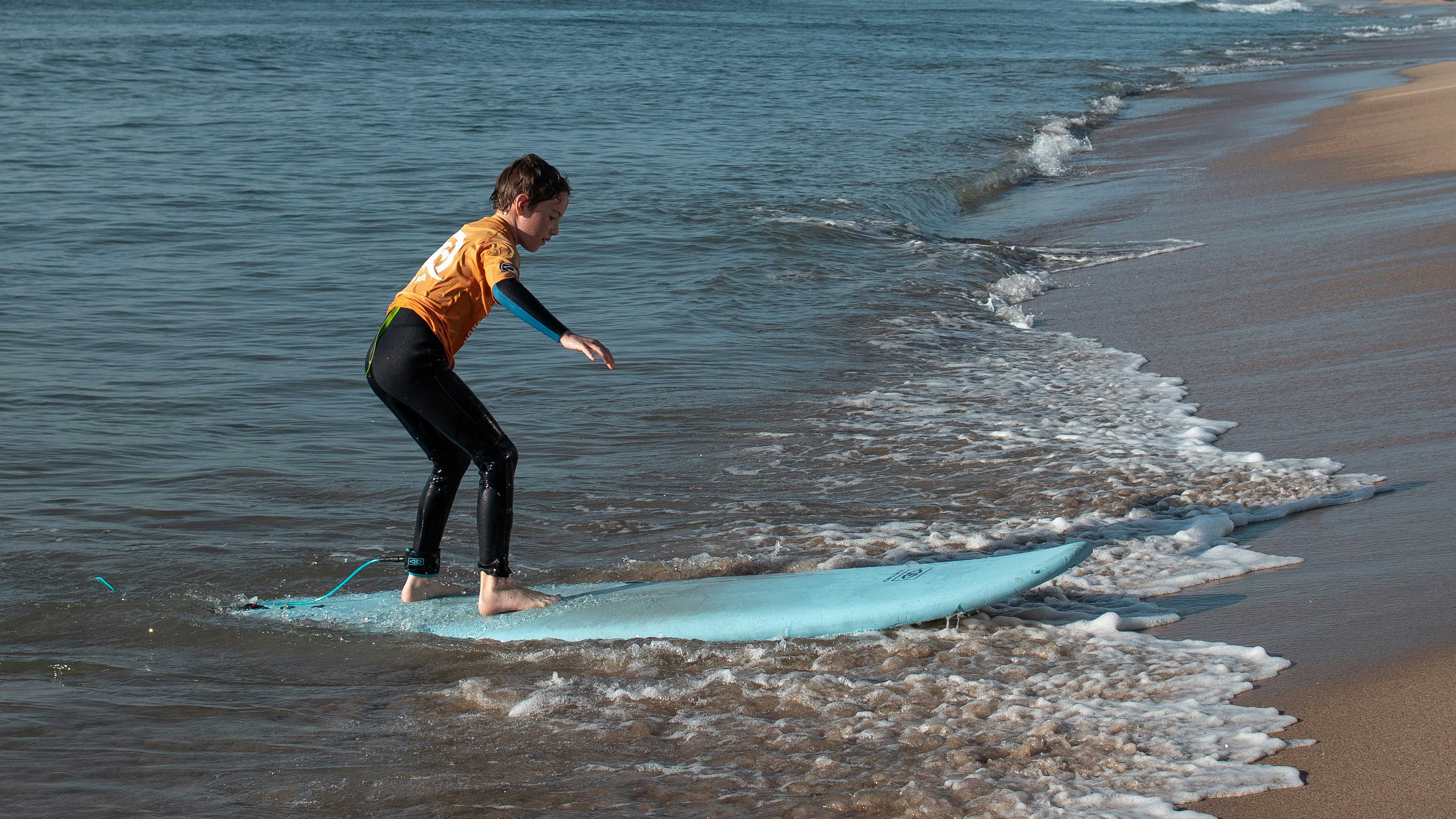 A man riding a surfboard on top of a wave