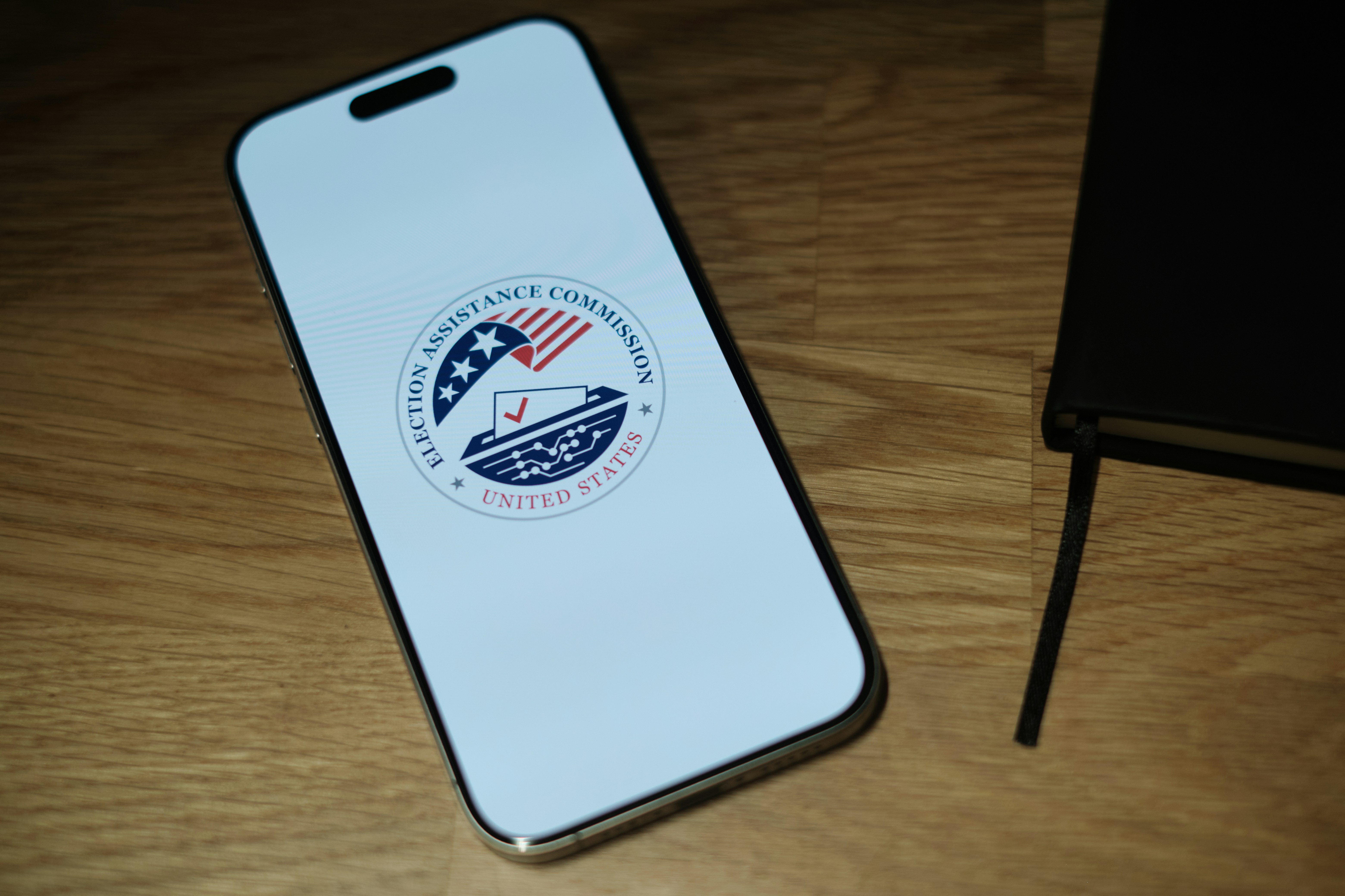 A cell phone sitting on top of a wooden table