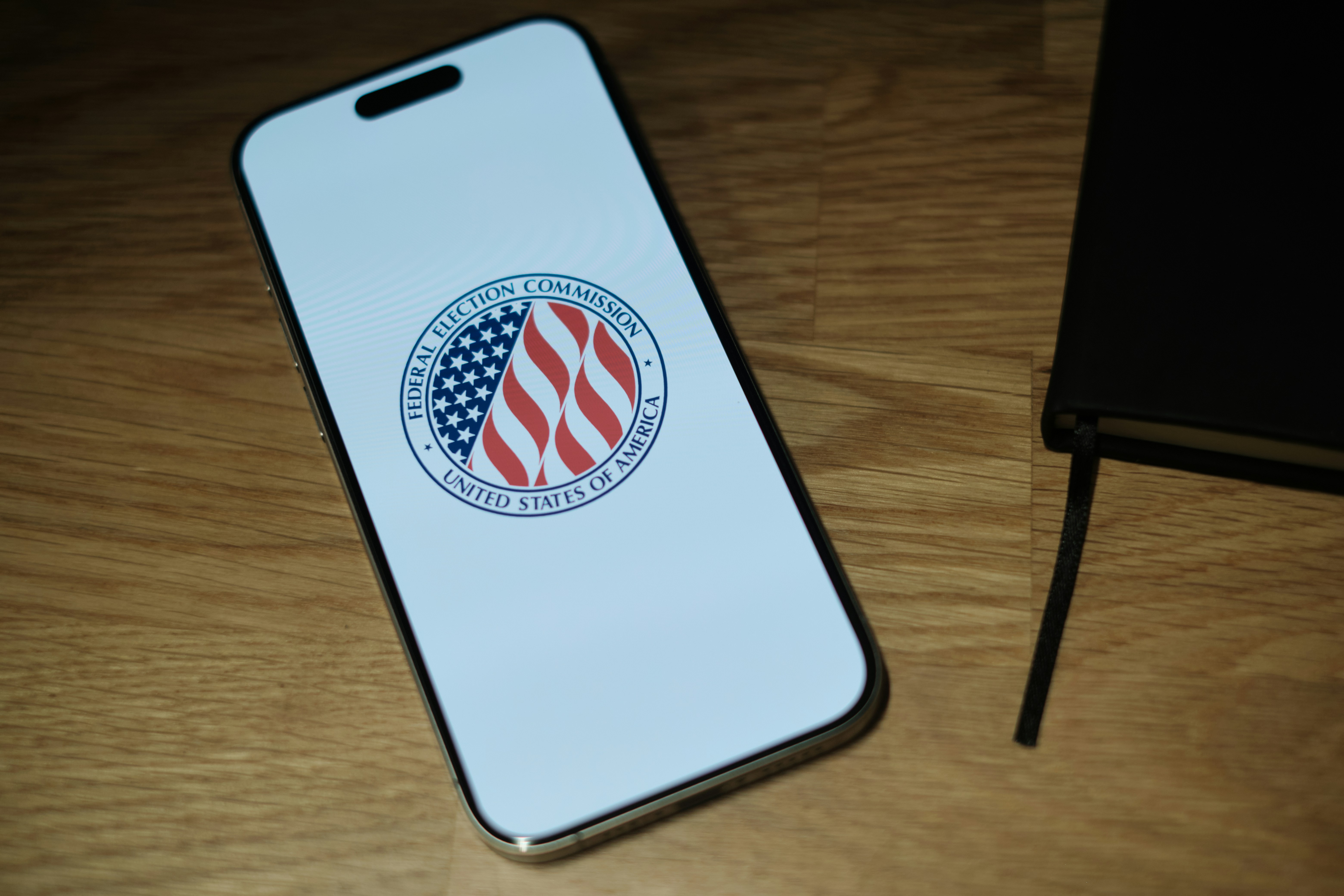 A cell phone sitting on top of a wooden table