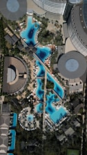 An aerial view of a city with a pool