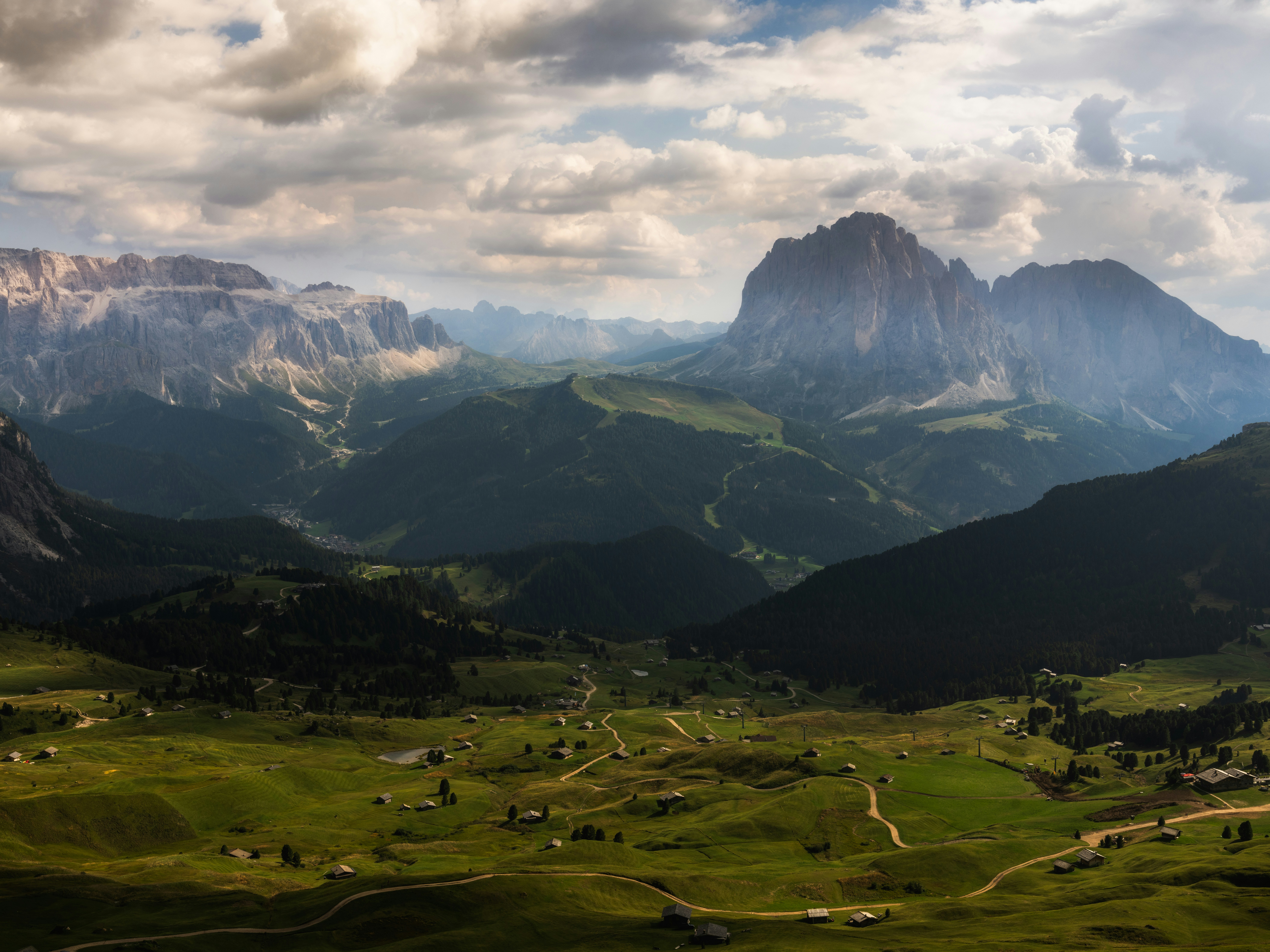 A scenic view of a mountain range with clouds in the sky
