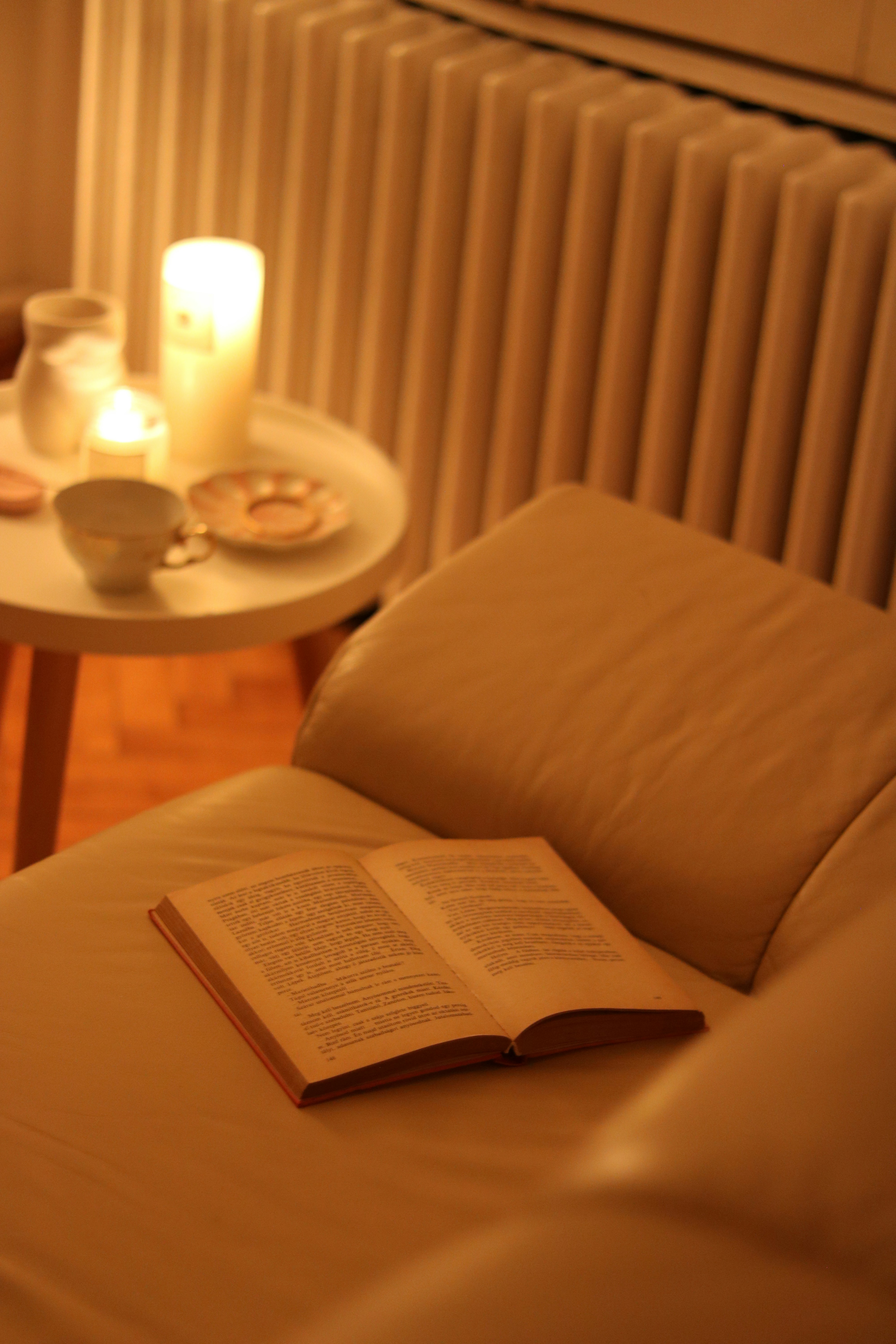 An open book on a chair next to a table