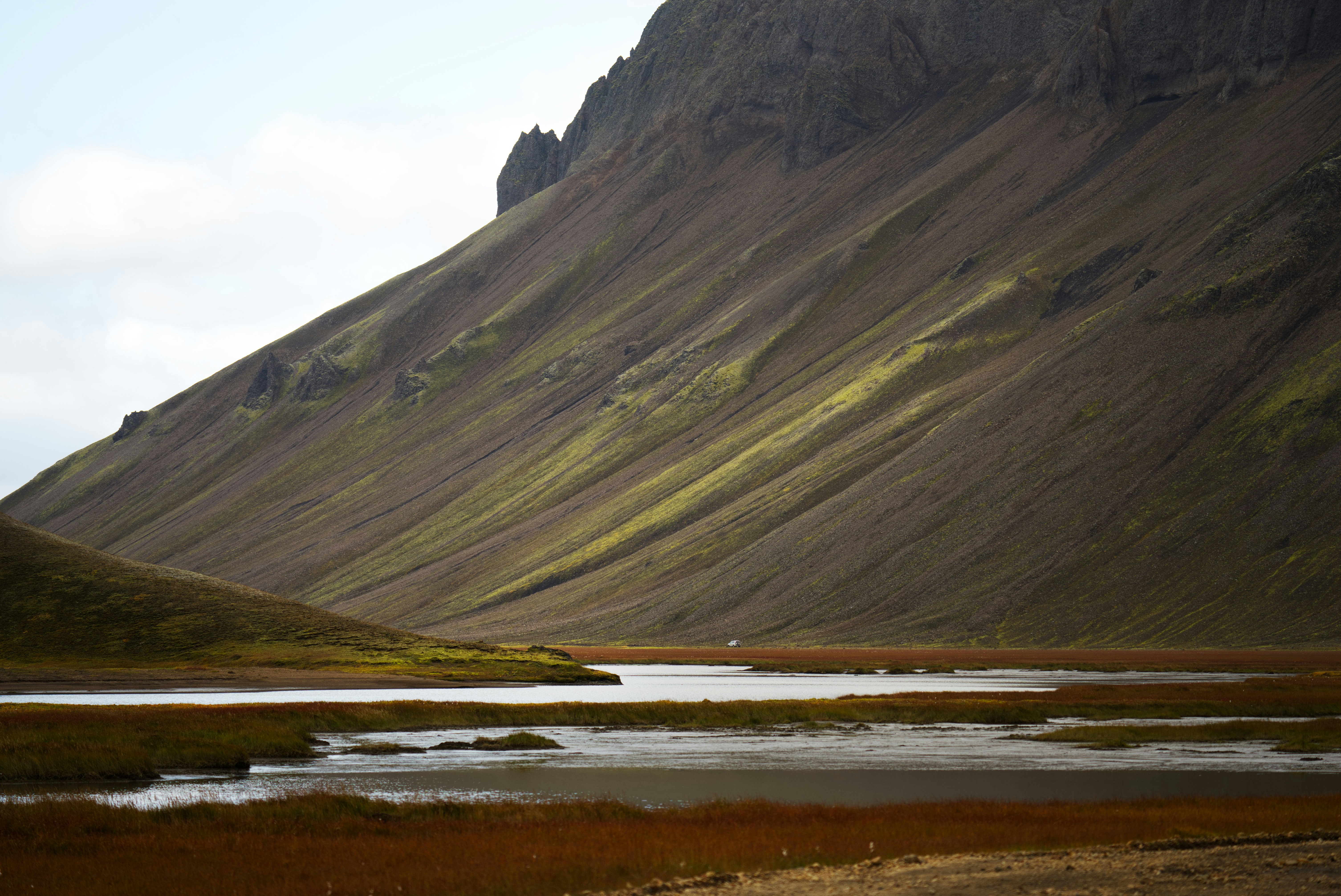 A mountain with a body of water in front of it