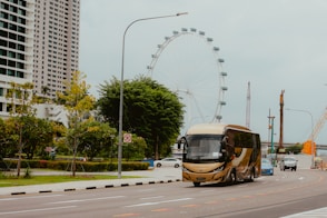 A bus driving down a street next to tall buildings
