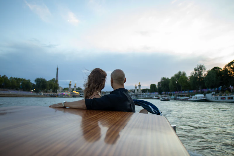 two people enjoying the water from a boat