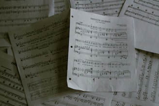A pile of sheet music sitting on top of a table