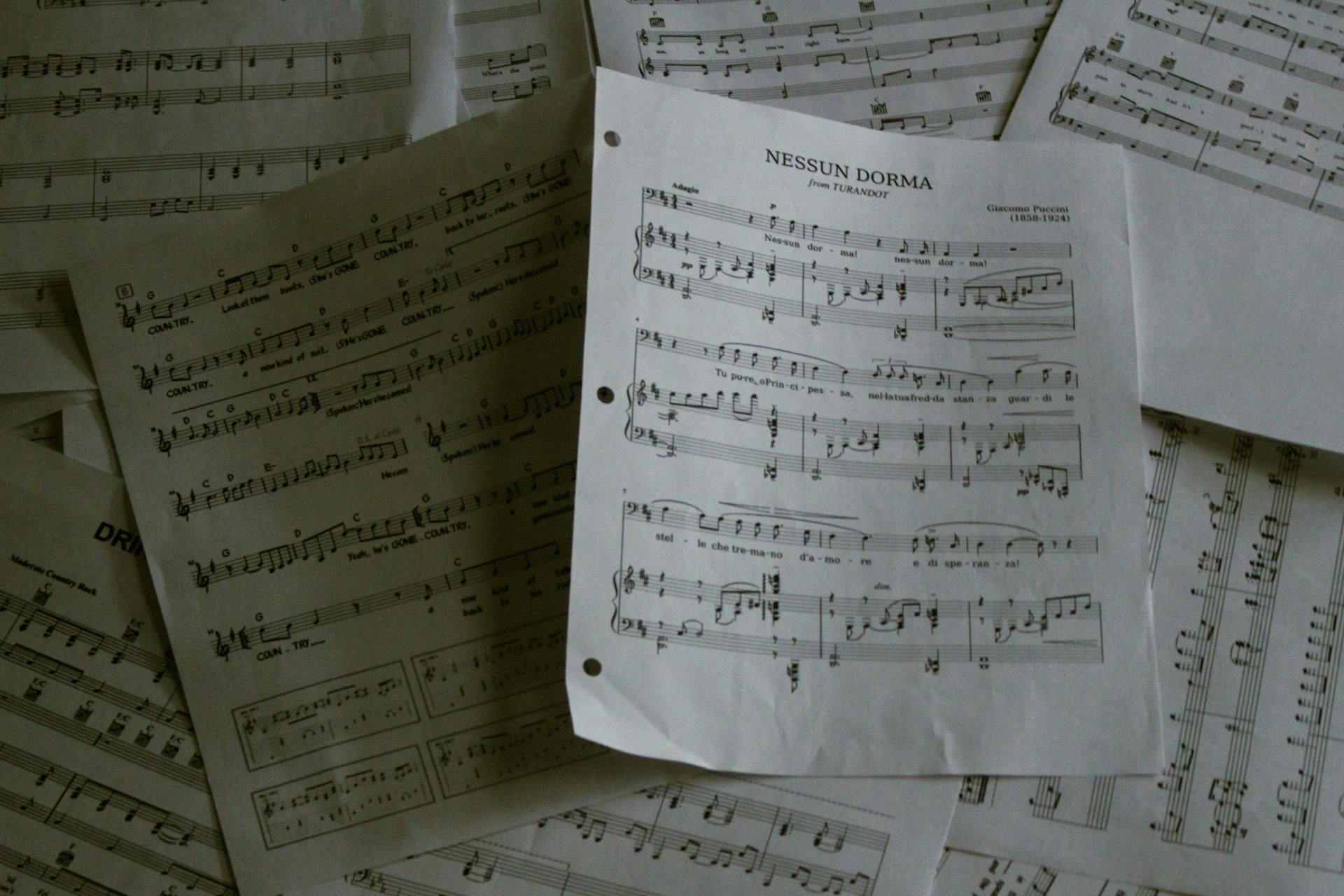 A pile of sheet music sitting on top of a table