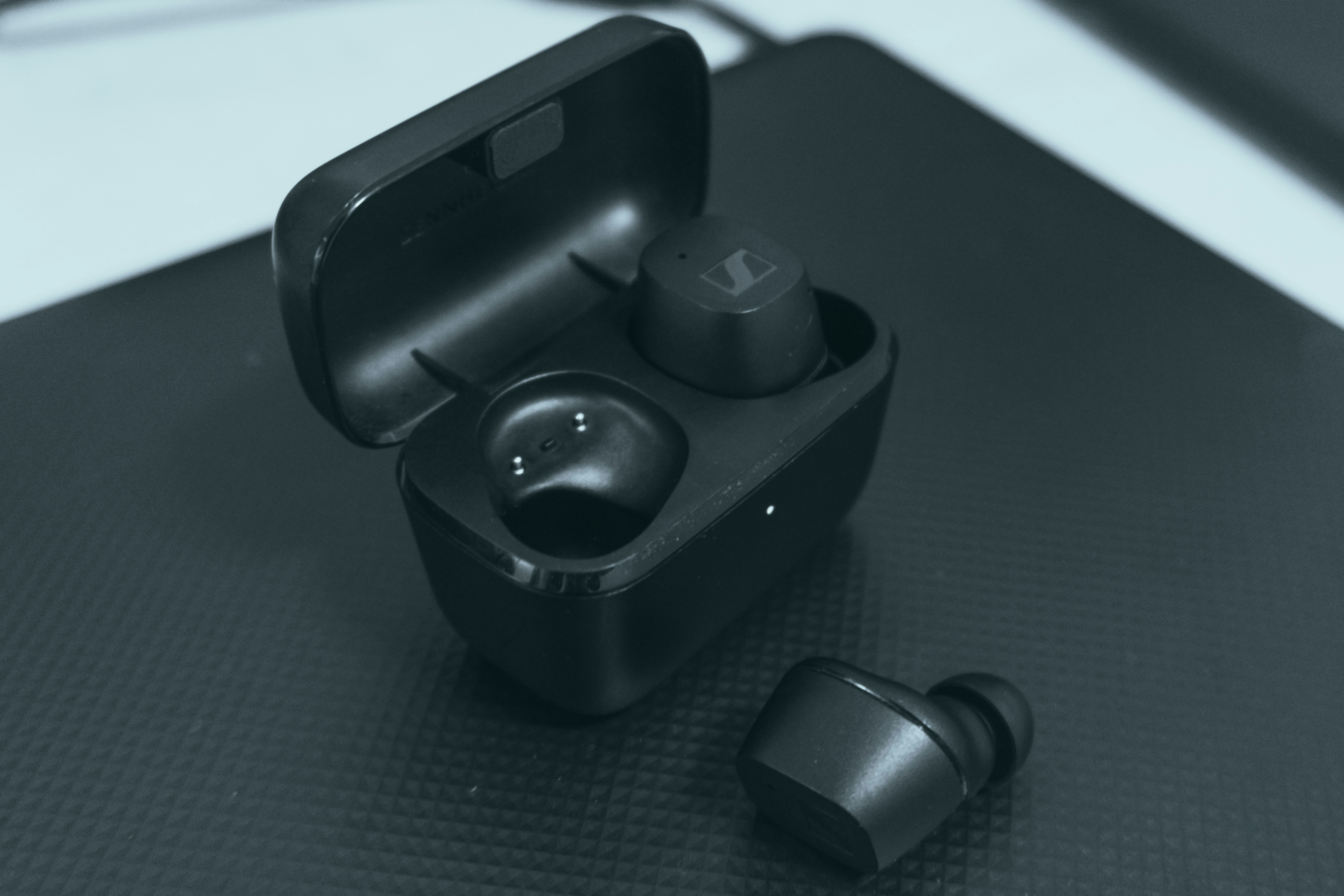 A pair of ear buds sitting on top of a table